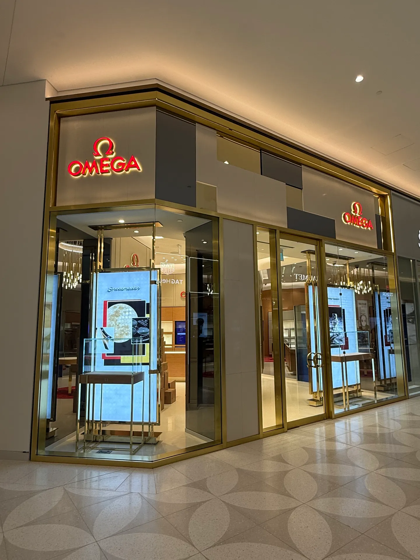 Luxury retail storefront glass with gold frames in a Vancouver mall